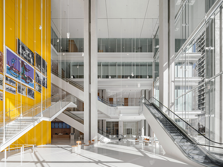 Interior of 20 metre high lobby with yellow wall